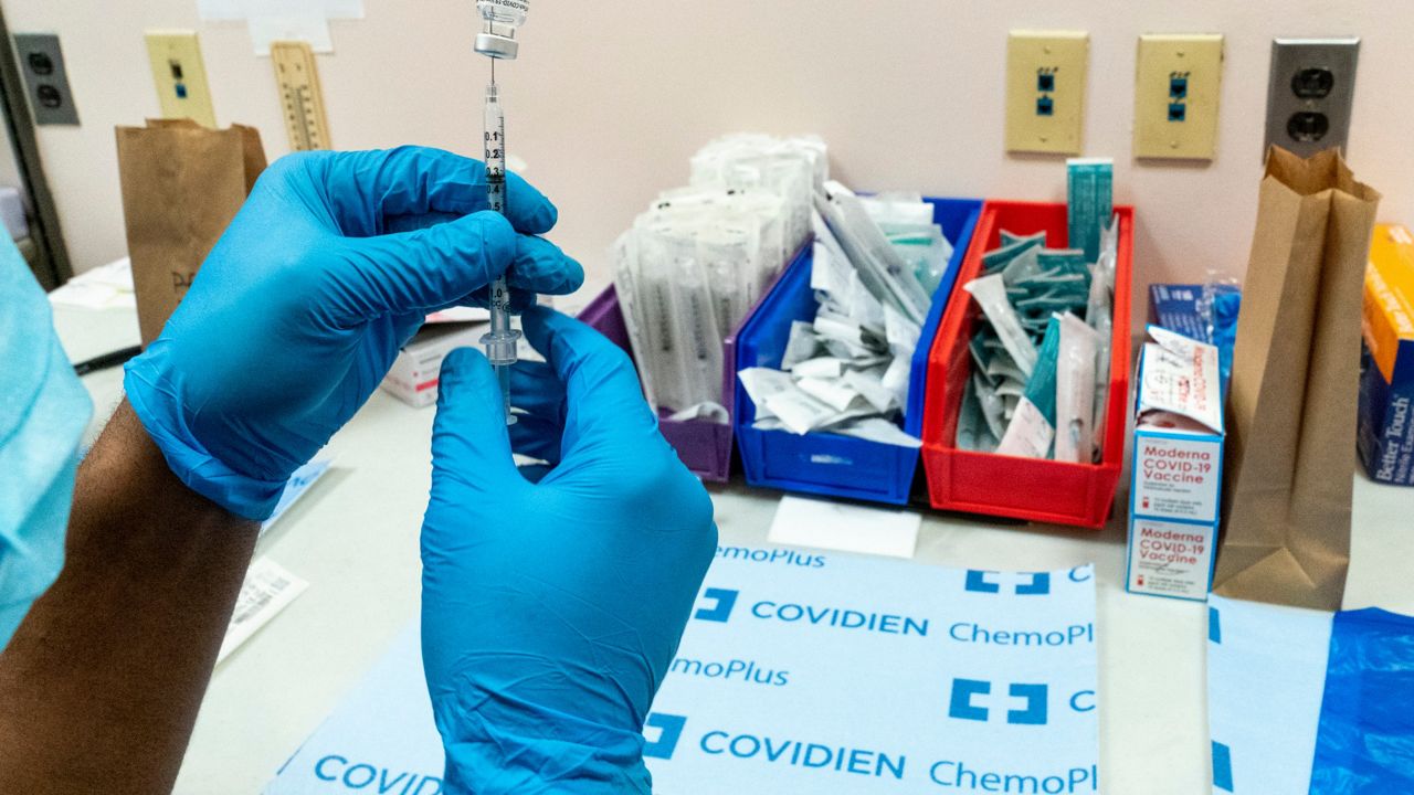 A pharmacist prepares a syringe with the Pfizer-BioNTech COVID-19 vaccine at a COVID-19 vaccination site at NYC Health + Hospitals Metropolitan, Thursday, Feb. 18, 2021, in New York.