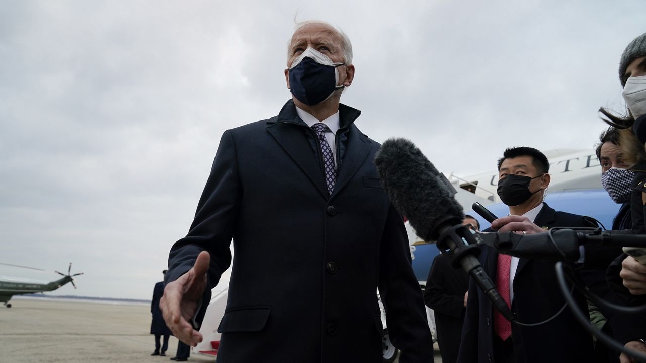 President Joe Biden speaks to member of the media after exiting Air Force One, Friday, Feb. 19, 2021, in Andrews Air Force Base, Md. (AP Photo/Evan Vucci)