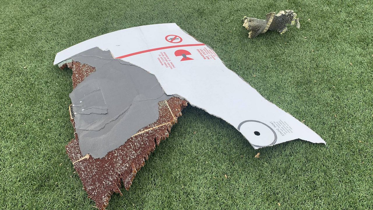 In this photo provided by the Broomfield Police Department on Twitter, debris is scattered across turf field at Commons Park, Saturday, Feb. 20, 2021, in Broomfield, Colo. The police ask that the area be avoided if possible. A commercial airliner dropped debris in Colorado neighborhoods during an emergency landing Saturday.The Broomfield Police Department said on Twitter that the plane landed safely at Denver International Airport and that no injuries had been reported from the incident. (Broomfield Police Department via AP)