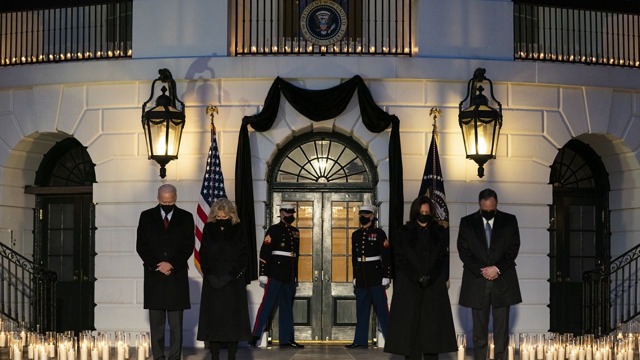 President Joe Biden, first lady Jill Biden, Vice President Kamala Harris, and Doug Emhoff participate in a moment of silence during a ceremony to honor the 500,000 Americans that died from COVID-19, at the White House, Monday, Feb. 22, 2021, in Washington. (AP Photo/Evan Vucci)