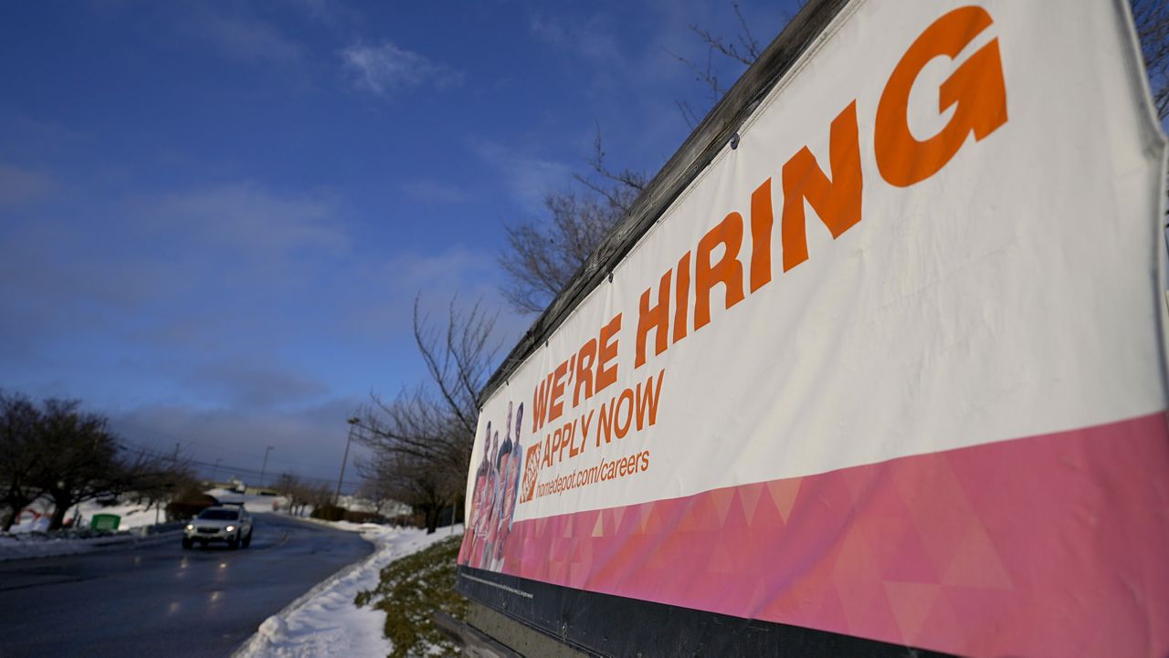 A sign announcing hiring is seen in the parking lot of a Home Depot, Monday, Feb. 22, 2021, in Cockeysville, Md. (AP Photo/Julio Cortez)