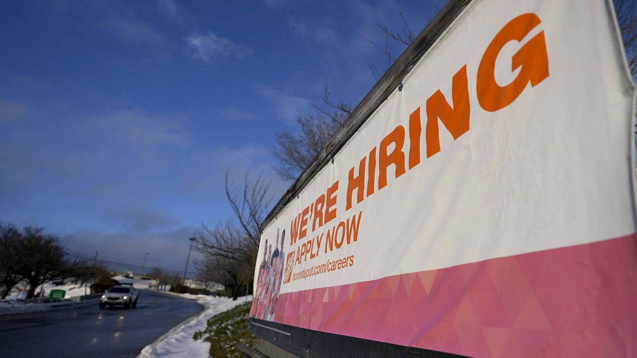 A sign announcing hiring is seen in the parking lot of a Home Depot in Cockeysville, Md. (AP Photo/Julio Cortez, File)