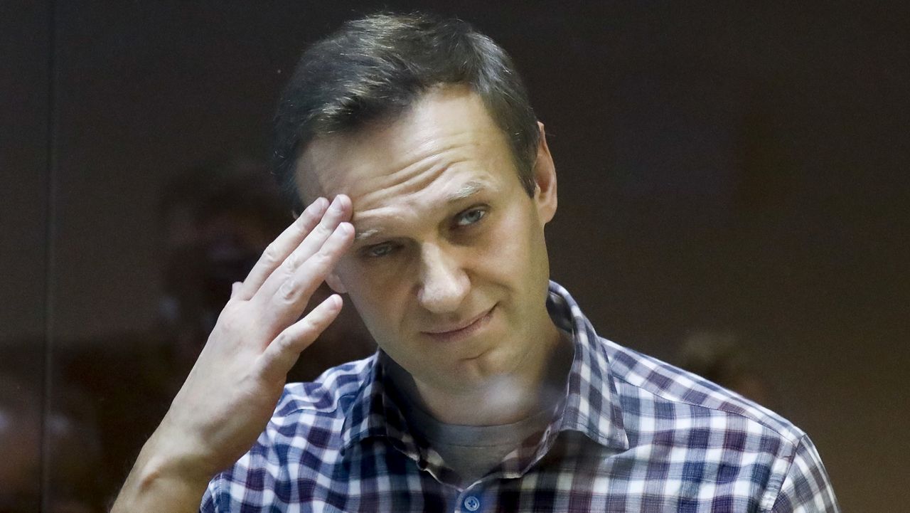 Russian opposition leader Alexei Navalny stands in a dock in the Babuskinsky District Court in Moscow, Russia, Saturday, Feb. 20, 2021. (AP Photo/Alexander Zemlianichenko)