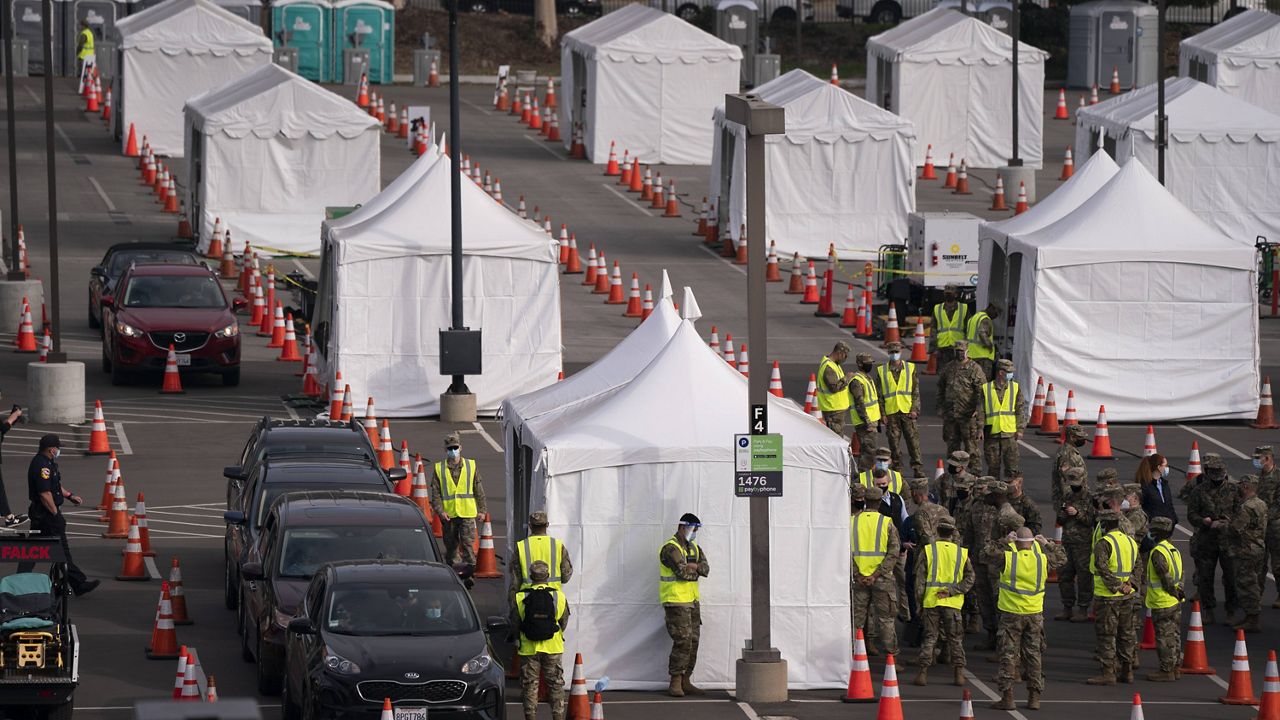 In this Feb. 16, 2021, file photo, motorists wait to get their COVID-19 vaccine at a federally-run vaccination site set up on the campus of California State University of Los Angeles, in Los Angeles. (AP Photo/Jae C. Hong, File)
