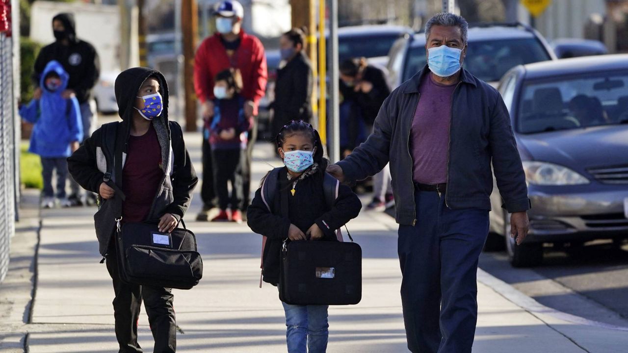 Students are dropped off at Newhall Elementary School on Feb. 25, 2021, in Santa Clarita, Calif. (AP Photo/Marcio Jose Sanchez)