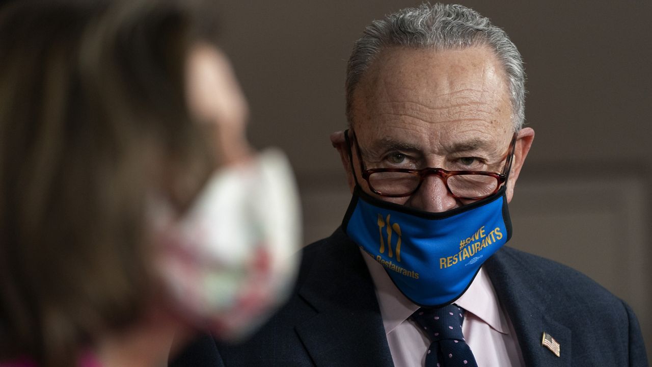 Senate Majority Leader Chuck Schumer, D-N.Y., right, watches as House Speaker Nancy Pelosi of Calif., speaks about the Congress Equality Act, Thursday, Feb. 25, 2021, on Capitol Hill in Washington. (AP Photo/Jacquelyn Martin)