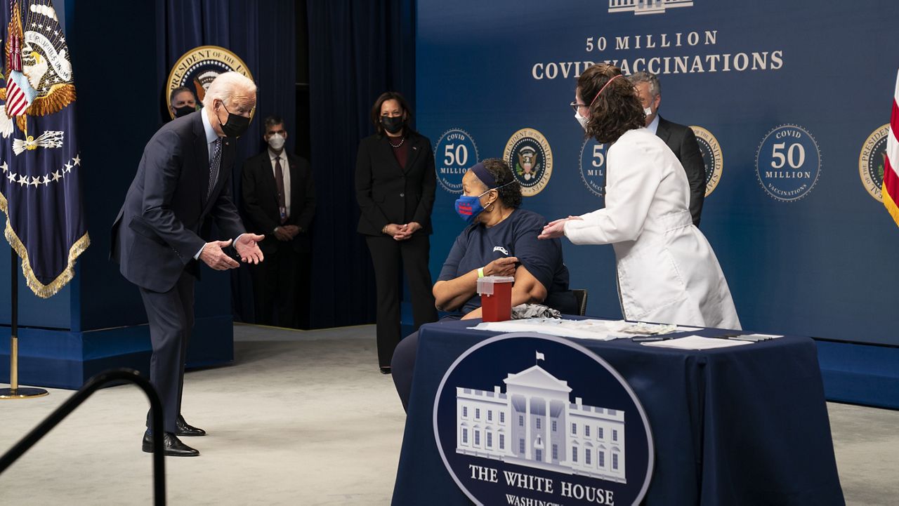 President Joe Biden talks to Linda Bussey before she received a vaccination, during an event to commemorate the 50 millionth COVID-19 shot, in the South Court Auditorium on the White House campus, Thursday, Feb. 25, 2021, in Washington. (AP Photo/Evan Vucci)