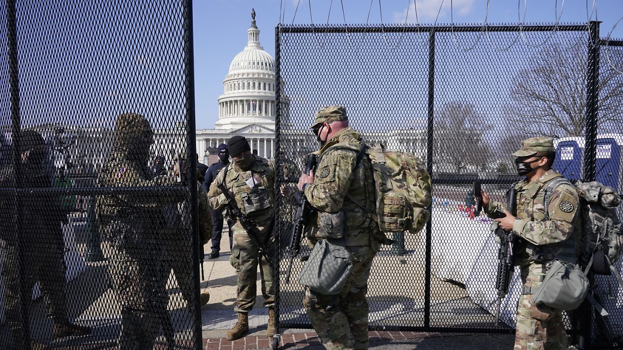 National Guard walk near the Capitol, Thursday, March 4, 2021, on Capitol Hill in Washington. (AP Photo/Jacquelyn Martin)