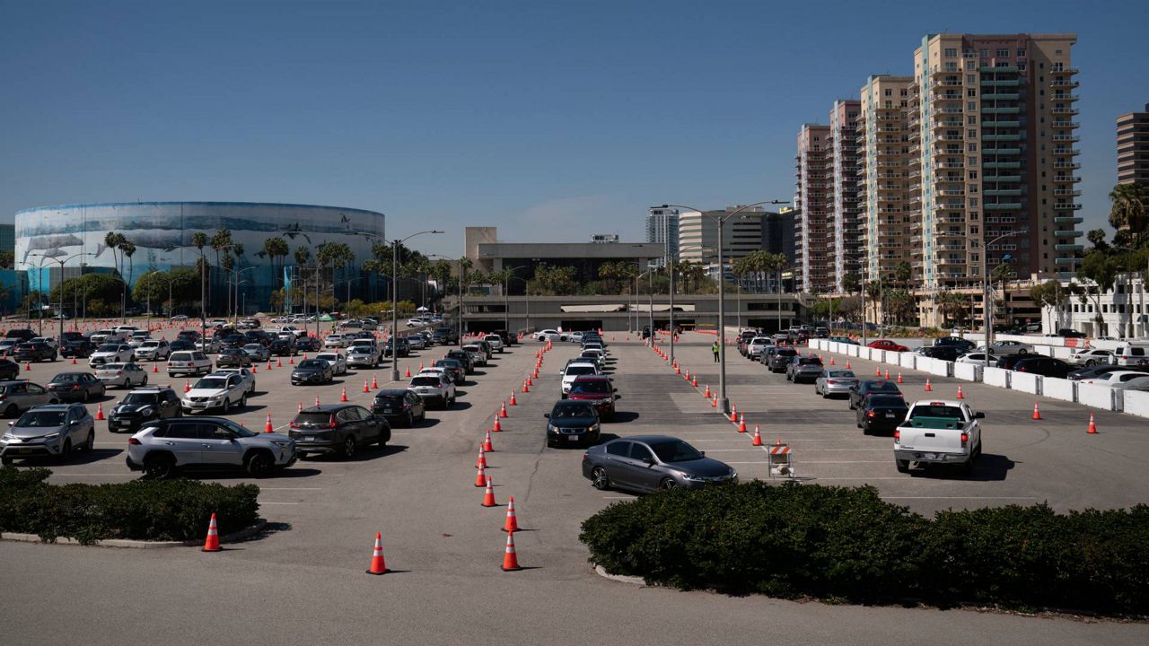 In this March 5, 2021, file photo, motorists line up at a COVID-19 vaccination site in Long Beach, Calif. (AP Photo/Jae C. Hong)