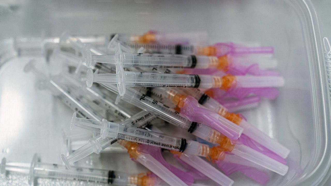A batch of syringes filled with Moderna COVID-19 vaccines are ready for inoculations at a COVID-19 mobile vaccination clinic at the Pomona Fairplex in Pomona, Calif., Friday, March 5, 2021. (AP Photo/Damian Dovarganes)