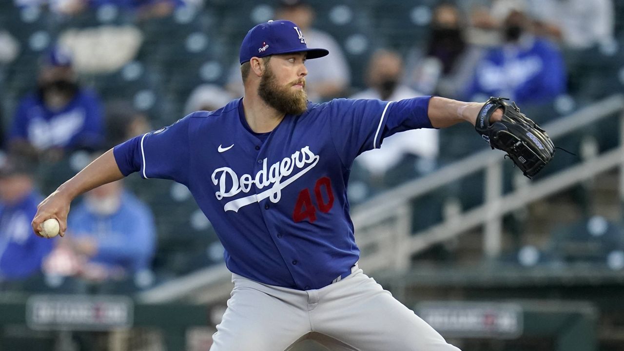 Los Angeles Dodgers starting pitcher Jimmy Nelson throws a pitch against the Cincinnati Reds during the first inning a spring training baseball game Tuesday, March 9, 2021, in Goodyear, Ariz. (AP Photo/Ross D. Franklin)