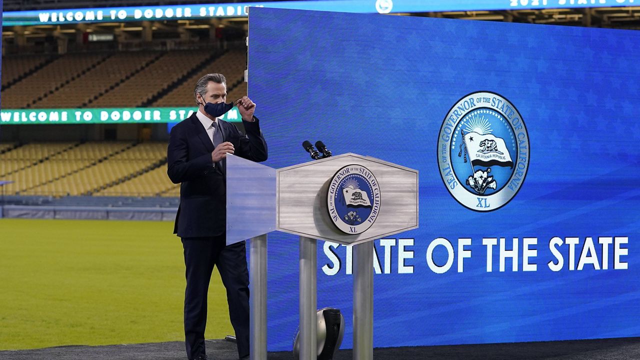 California Gov. Gavin Newsom takes his mask off before to delivering his State of the State address from Dodger Stadium Tuesday, March 9, 2021, in Los Angeles. (AP Photo/Mark J. Terrill)