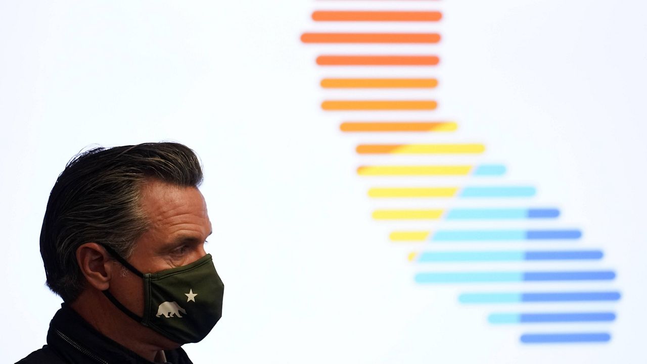 California Gov. Gavin Newsom wears a mask during a visit to a vaccination center Wednesday, March 10, 2021, in South Gate, Calif. (AP Photo/Marcio Jose Sanchez)
