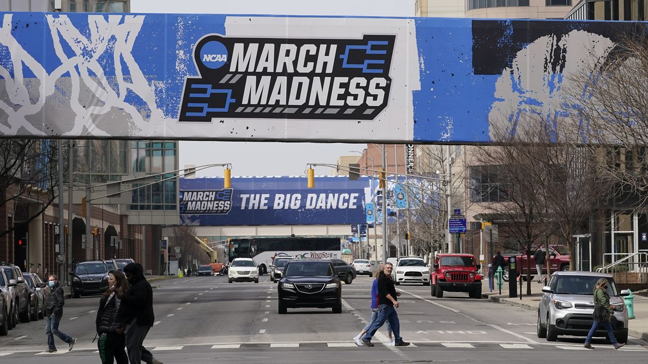 March Madness banners for the NCAA college basketball tournament cover crosswalks in downtown Indianapolis, Wednesday, March 17, 2021. (AP Photo/Darron Cummings)