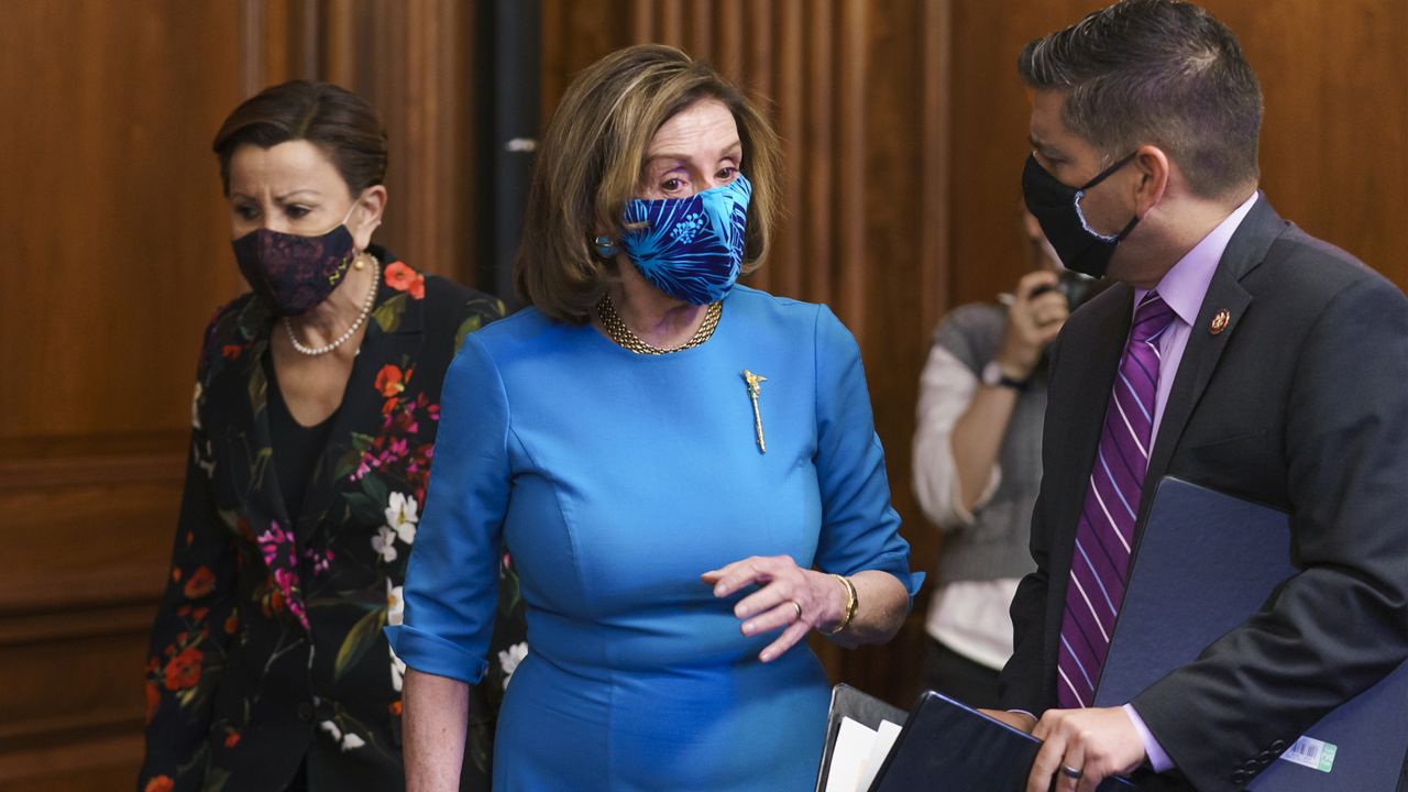 Speaker of the House Nancy Pelosi, D-Calif., center, is flanked by Rep. Nydia Velazquez, D-N.Y., left, and Rep. Raul Ruiz, D-Calif., chairman of the House Hispanic Caucus, ahead of the vote on the American Dream and Promise Act of 2021, a bill to help reform the immigration system, at the Capitol in Washington, Thursday, March 18, 2021. (AP Photo/J. Scott Applewhite)