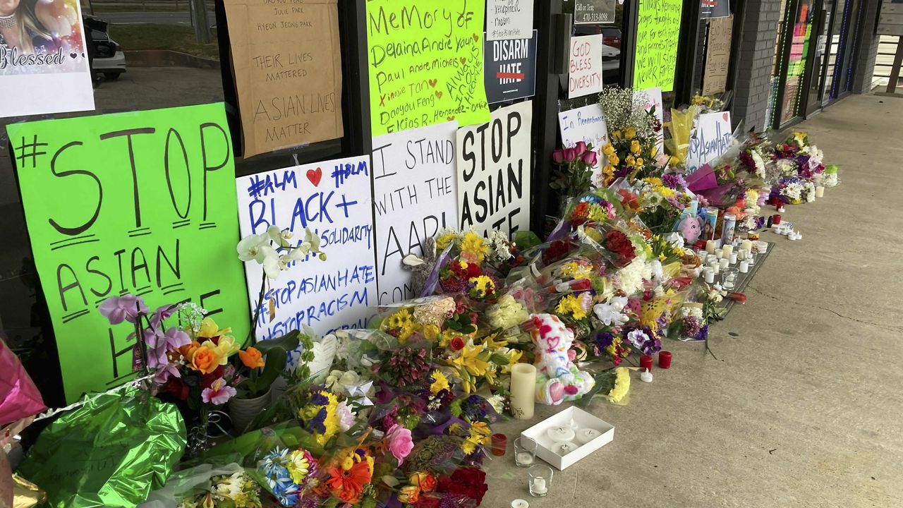 A make-shift memorial is seen Friday, March 19, 2021, in Acworth, Ga., in the aftermath of shootings. Eight people killed Tuesday in shootings at three metro Atlanta massage businesses. Police have charged a 21-year-old Robert Aaron Long with the slayings. (AP Photo/Candice Choi)