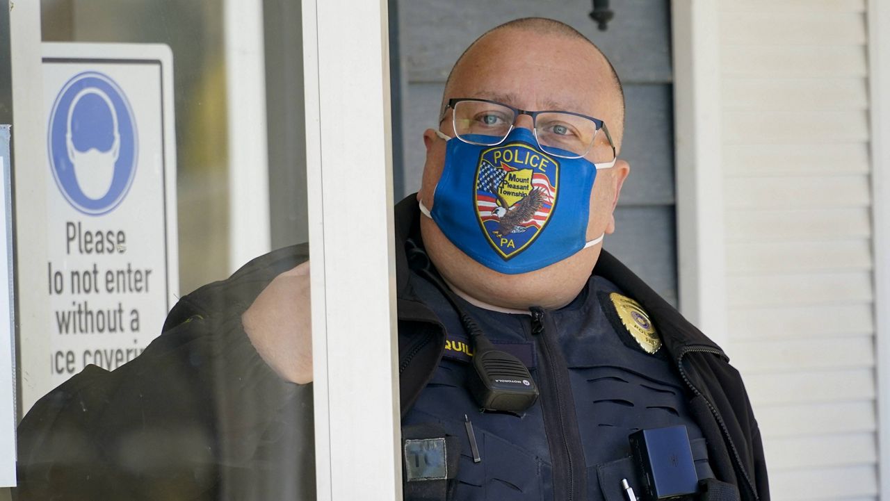 Mount Pleasant Township Police Chief Lou McQuillan answers the door at the municipal building in Hickory, Pa., on March 15. (AP Photo/Keith Srakocic)