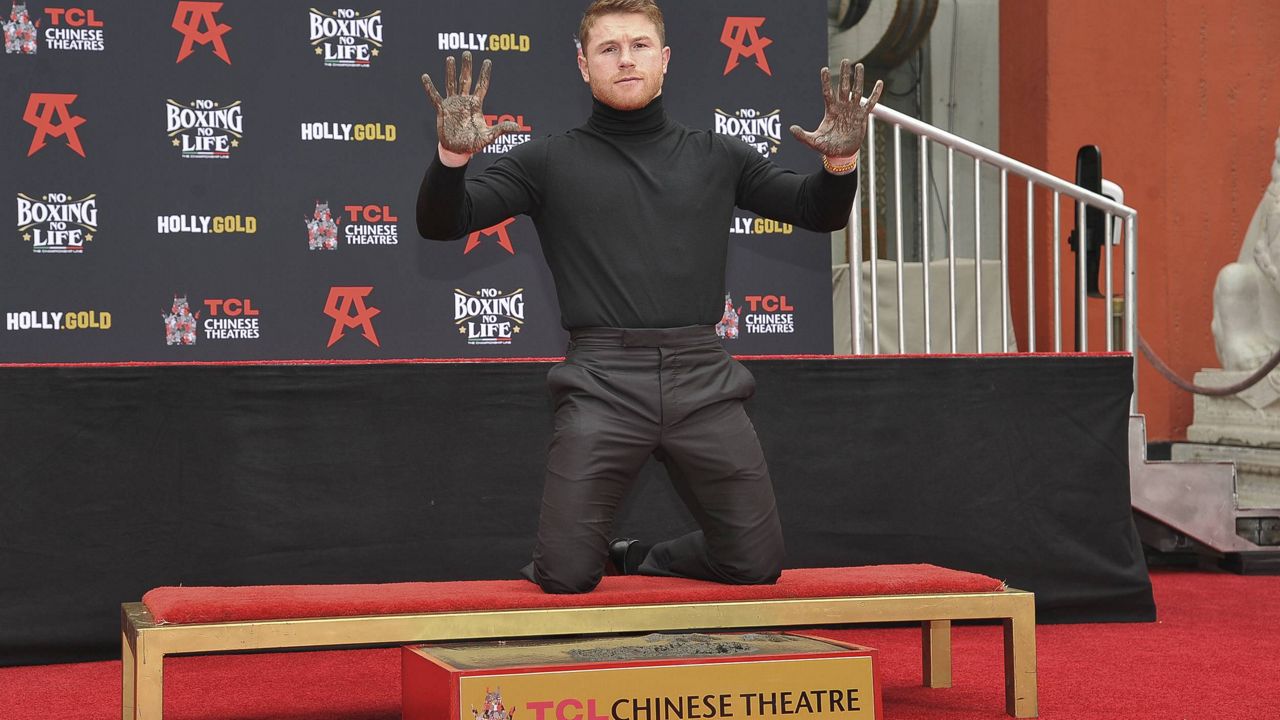 Boxer Canelo Alvarez poses for photos after placing his hands in cement during a ceremony in his honor on Saturday, March 20, 2021, in Los Angeles. (Photo by Richard Shotwell/Invision/AP)