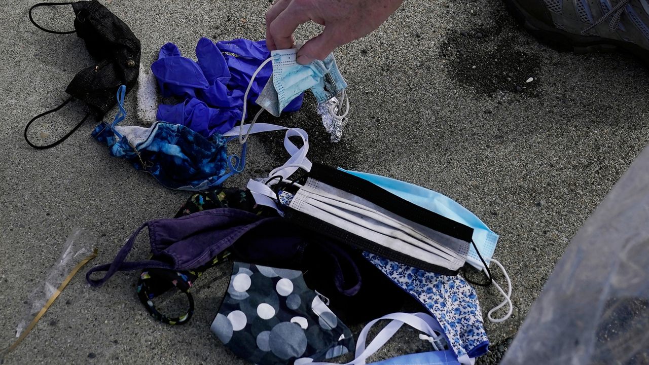 FILE: Face masks that were found discarded on the beach as volunteers clean areas near Sharp Park Beach in Pacifica, Calif., Wednesday, March 17, 2021. (AP Photo/Jeff Chiu)