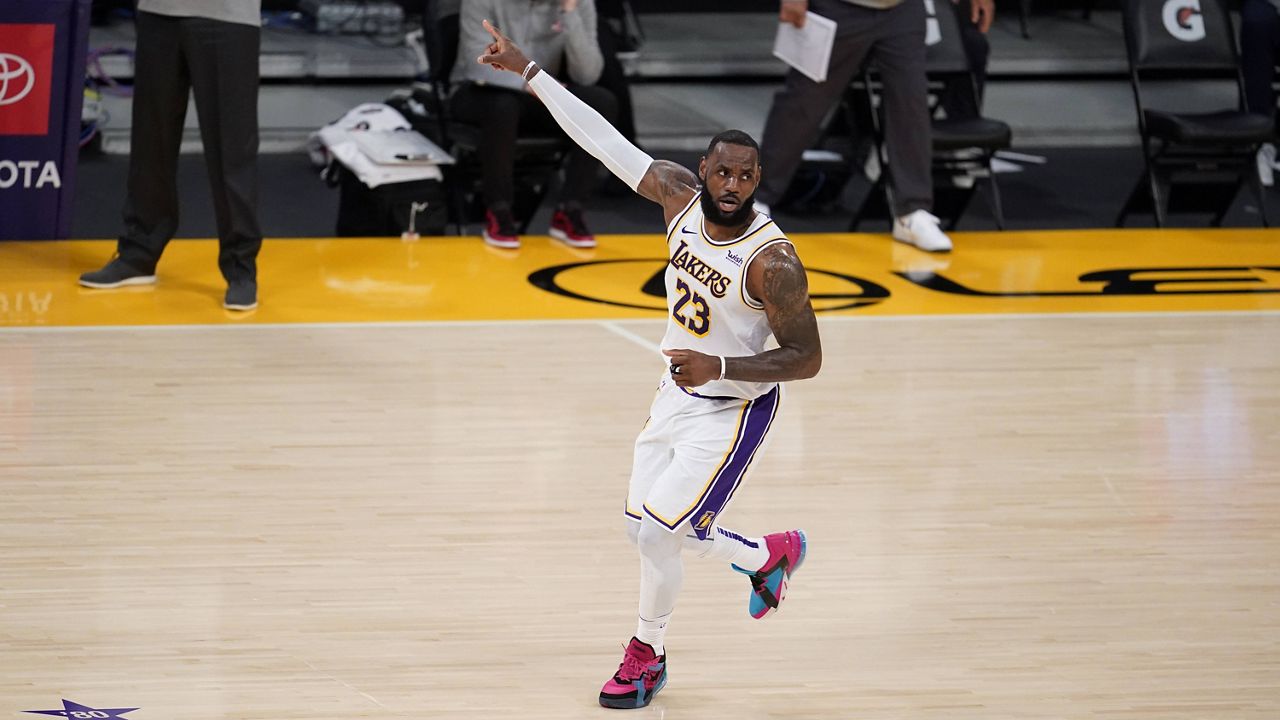 Los Angeles Lakers forward LeBron James (23) signals during the first half of an NBA basketball game against the Atlanta Hawks Saturday, March 20, 2021, in Los Angeles. (AP Photo/Marcio Jose Sanchez)