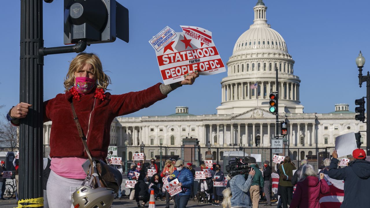 Advocates for statehood for the District of Columbia rally near the Capitol prior to a House of Representatives hearing on creating a fifty-first state, in Washington, Monday, March 22, 2021. (AP Photo/J. Scott Applewhite)