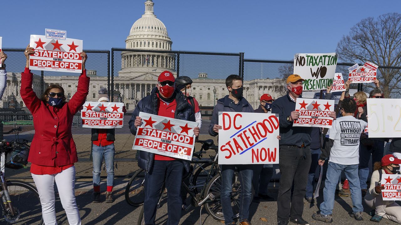 Advocates for statehood for the District of Columbia rally near the Capitol prior to a House of Representatives hearing on creating a fifty-first state, in Washington, Monday, March 22, 2021. The activists were able to gather near the Capitol building after the outer perimeter security fencing was dismantled this weekend. (AP Photo/J. Scott Applewhite)