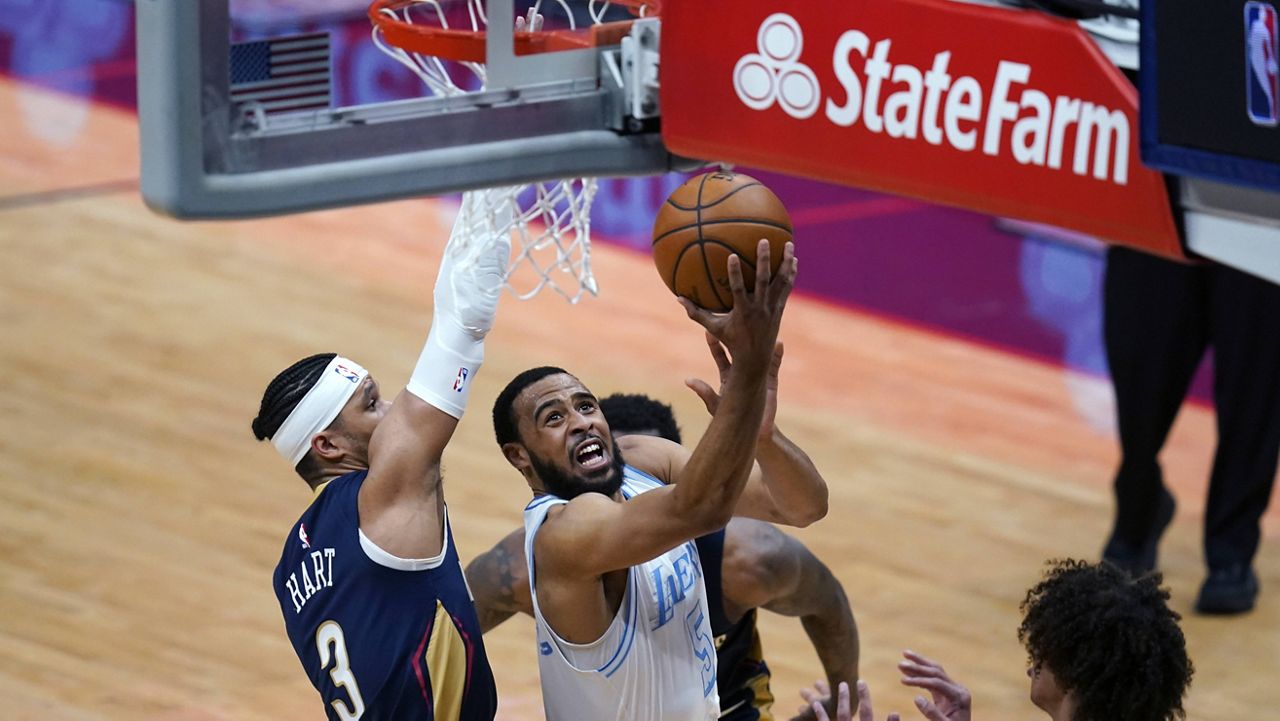 Los Angeles Lakers guard Talen Horton-Tucker (5) goes to the basket against New Orleans Pelicans guard Josh Hart (3) during the first half of an NBA basketball game in New Orleans, Tuesday, March 23, 2021. (AP Photo/Gerald Herbert)