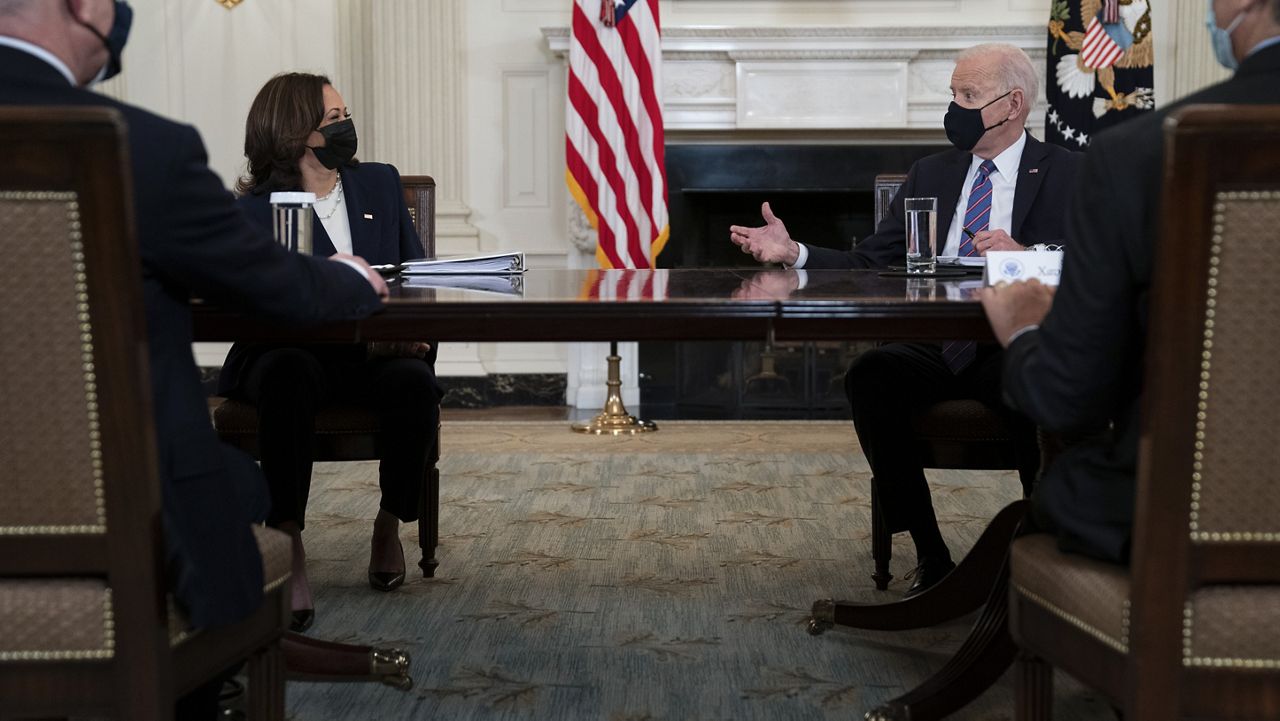 President Joe Biden speaks with Vice President Kamala Harris about the southern border during a meeting in the State Dining Room of the White House, Wednesday, March 24, 2021, in Washington. (AP Photo/Evan Vucci)