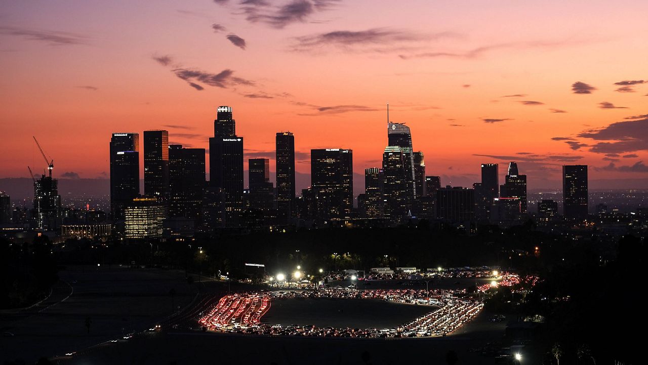 In this Jan. 4, 2021, file photo, motorists queue to take a coronavirus test in a parking lot at Dodger Stadium in Los Angeles. (AP Photo/Ringo H.W. Chiu, File)