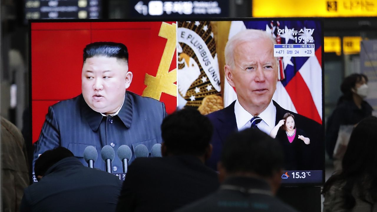 Commuters watch a TV showing a file image of North Korean leader Kim Jong Un and U.S. President Joe Biden during a news program at the Suseo Railway Station in Seoul, South Korea, Friday. March 26, 2021. (AP Photo/Ahn Young-joon)