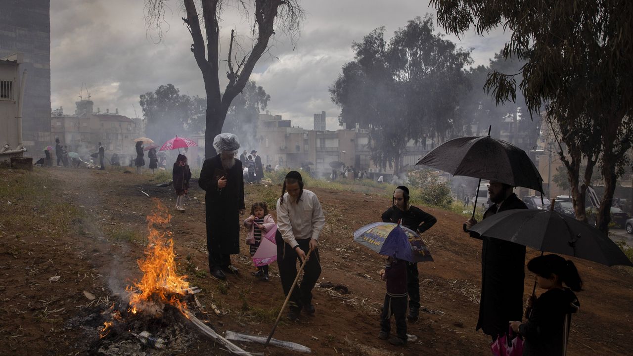 Ultra-Orthodox Jewish men and children burn leaves and items in final preparation for the Passover holiday in the ultra-Orthodox Jewish town of Bnei Brak, near Tel Aviv, Israel, Friday, March 26, 2021. Jews are forbidden to eat leavened foodstuffs during the Passover holiday that celebrates the biblical story of the Israelites' escape from slavery and exodus from Egypt. (AP Photo/Oded Balilty)