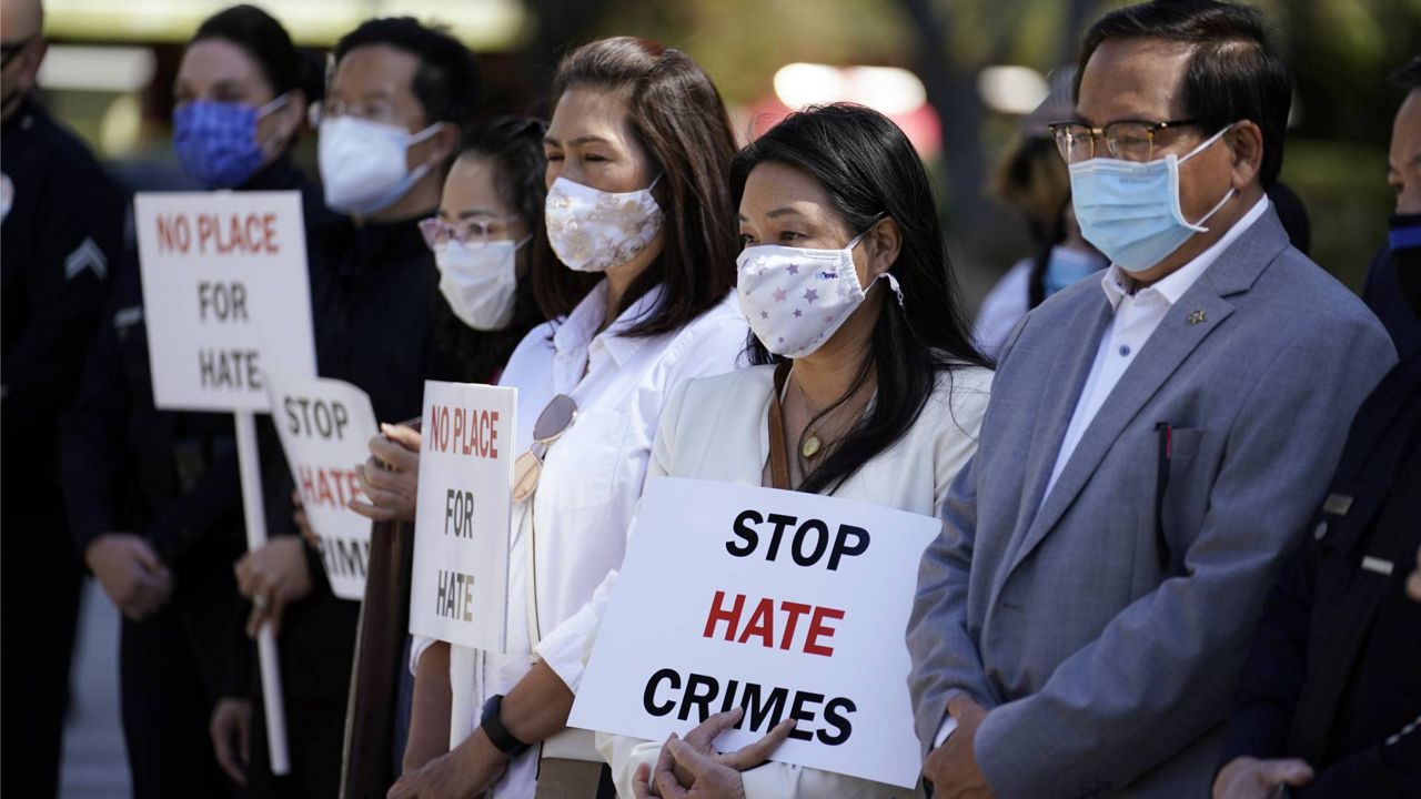 In this Monday, March 22, 2021 file photo, demonstrators hold signs during a press conference calling to a halt on violence against Asian Americans in Los Angeles. (AP Photo/Marcio Jose Sanchez)