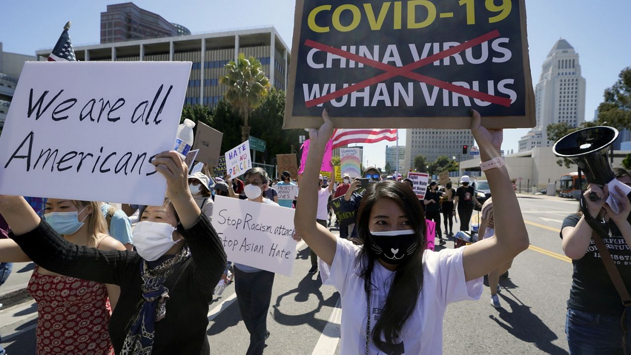 Protestors march at a rally against Asian hate crimes past the Los Angeles Federal Building in downtown Los Angeles, Saturday, March 27, 2021. (AP Photo/Damian Dovarganes)