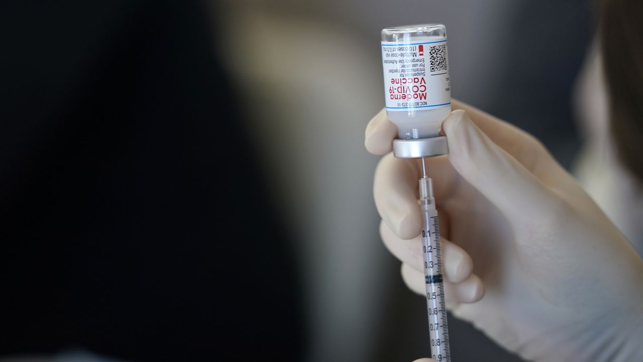 A worker readies syringes with the Moderna COVID-19 vaccine Monday, March 29, 2021, at "Vaccine Fest," a 24-hour COVID-19 mass vaccination event in Metairie, La., just outside New Orleans. (AP Photo/Gerald Herbert)