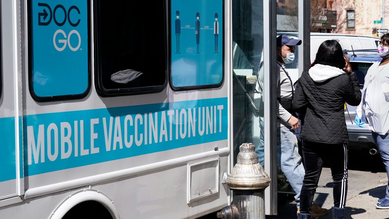 A man exits a mobile vaccination van after receiving a COVID-19 vaccine administered by NYC Test & Trace Corps on Monday, March 29, 2021, in New York.