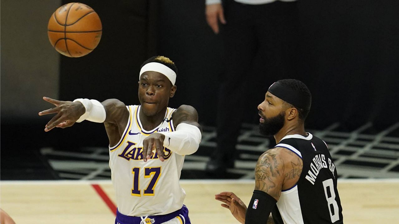 Lakers guard Dennis Schroder (17) passes in front of Los Angeles Clippers forward Marcus Morris Sr. (8) during an NBA basketball game Sunday, April 4, 2021, in L.A. (AP Photo/Marcio Jose Sanchez)