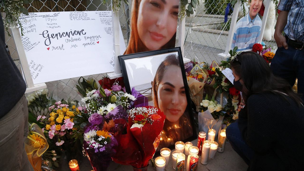 In this photo provided by Guillermo Lefranc, members of the community and family members hold a vigil outside the scene of a shooting in Orange, Calif., Sunday, April 4, 2021. (Guillermo Lefranc via AP)