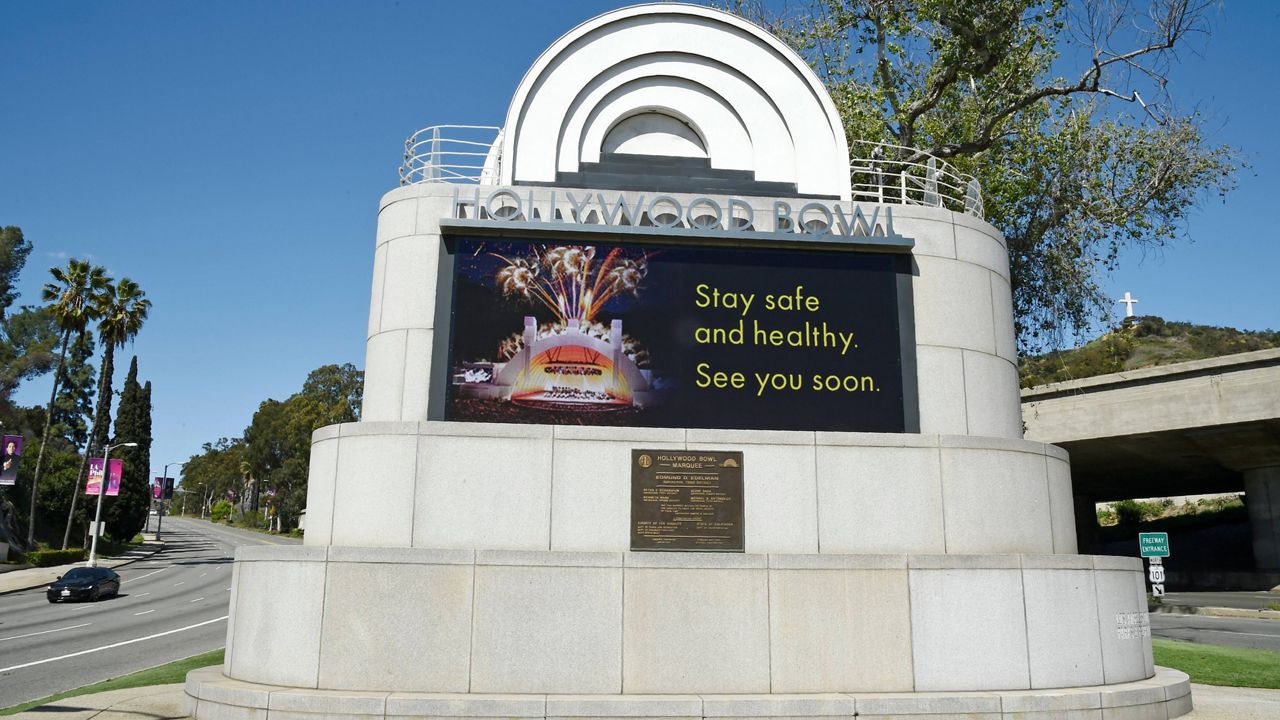 This March 27, 2020, file photo shows a video monitor at the entrance to the Hollywood Bowl with a coronavirus-related message in Los Angeles. (AP Photo/Chris Pizzello, File)