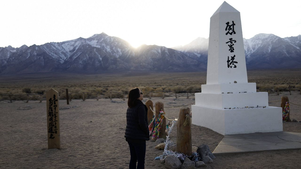 In this Feb. 17, 2020, file photo Lori Matsumura visits the cemetery at the Manzanar National Historic Site near Independence, Calif. (AP Photo/Brian Melley, File)