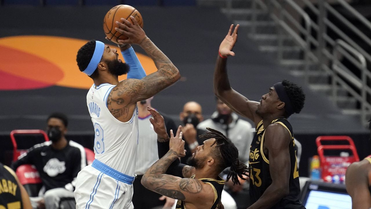 Los Angeles Lakers forward Markieff Morris (88) shoots over Toronto Raptors forward Pascal Siakam (43) and guard Gary Trent Jr. (33) during the first half of an NBA basketball game Tuesday, April 6, 2021, in Tampa, Fla. (AP Photo/Chris O'Meara)