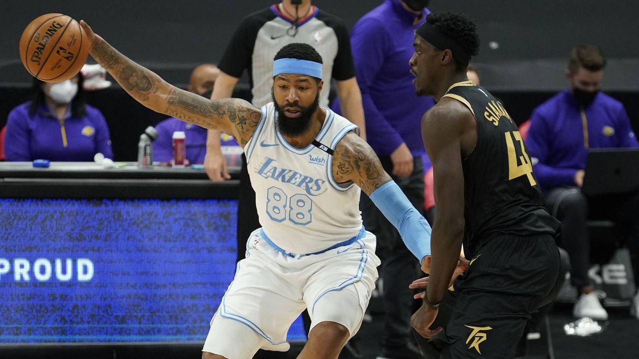 Lakers forward Markieff Morris nearly loses the ball as he works around Toronto Raptors forward Pascal Siakam (43) during an NBA game April 6, 2021, in Tampa, Fla. (AP Photo/Chris O'Meara)