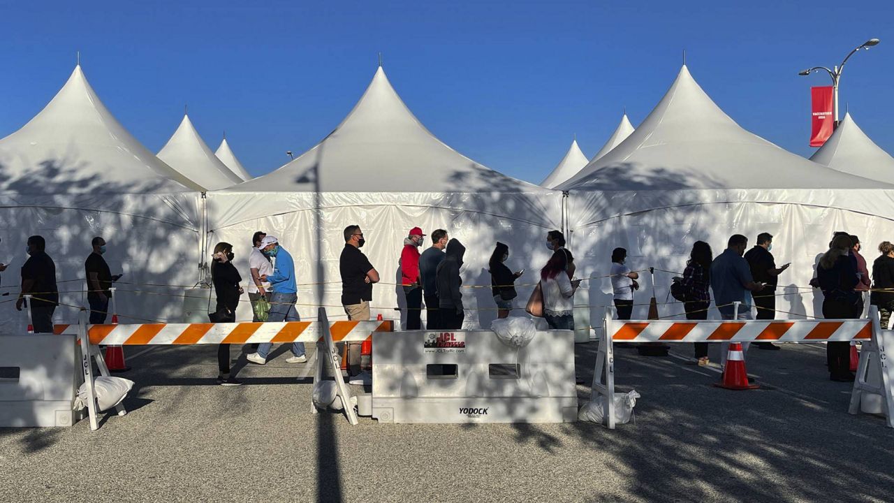 People line up for the COVID-19 Johnson and Johnson vaccine outside Pierce College in the Woodland Hills section of Los Angeles on Wednesday, April 7, 2021. (AP Photo/Richard Vogel)