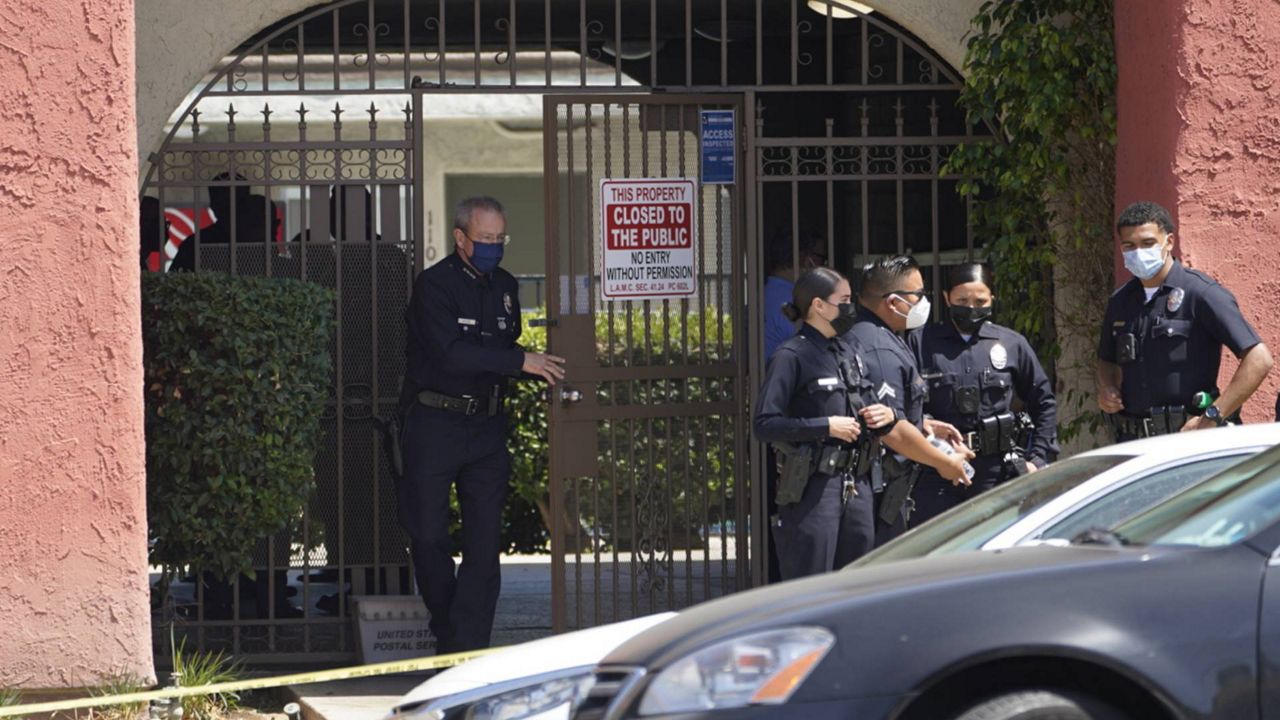 Los Angeles Police Chief Michel Moore exits an apartment complex as police investigate in Reseda, Calif., Saturday, April 10, 2021. (AP Photo/Damian Dovarganes)