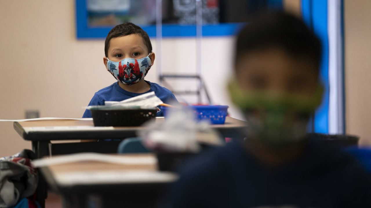 Nathan Ramos sits in a kindergarten classroom on the first day of in-person learning at Maurice Sendak Elementary School in Los Angeles, April 13, 2021. (AP Photo/Jae C. Hong)