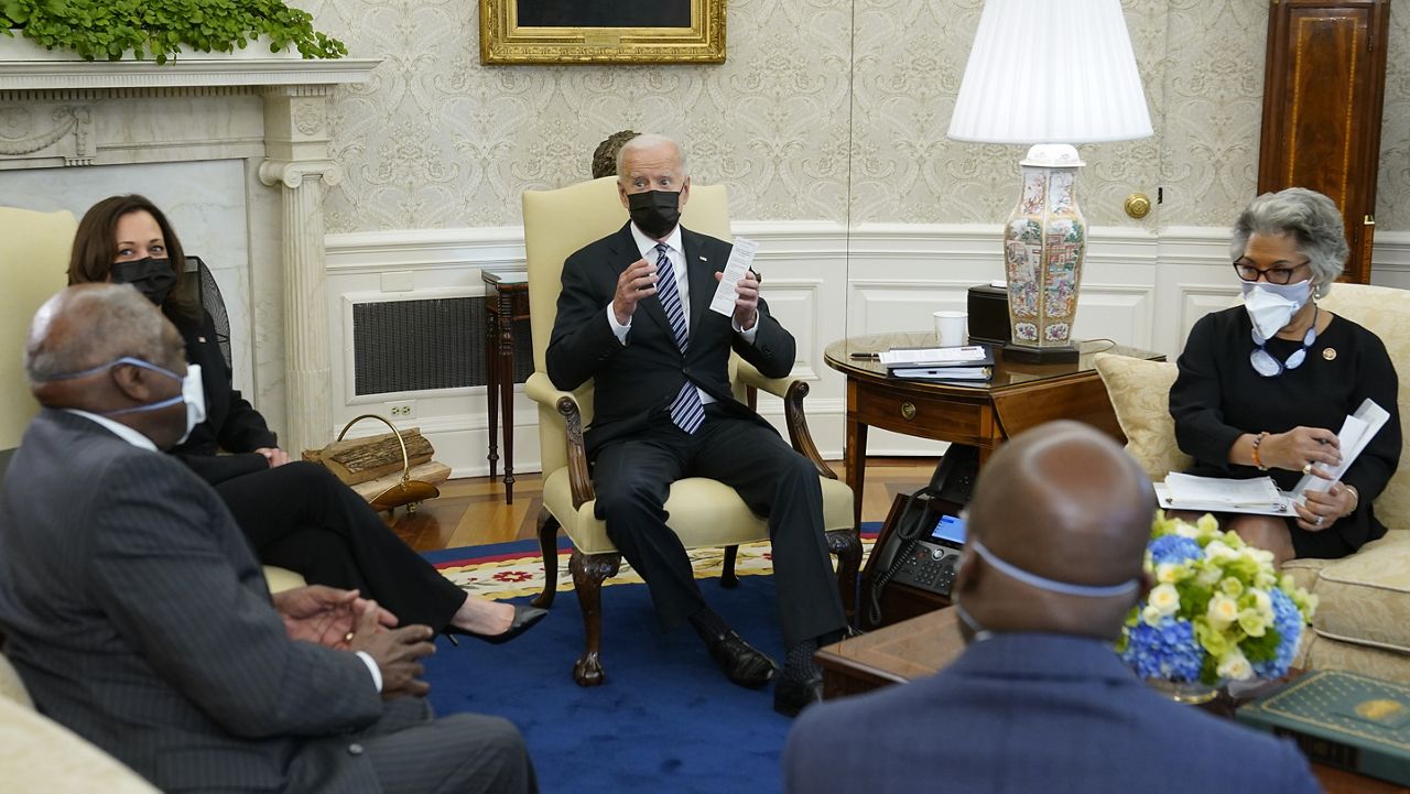 President Joe Biden speaks as he and Vice President Kamala Harris meet with members of the Congressional Black Caucus in the Oval Office of the White House, Tuesday, April 13, 2021, in Washington. Sitting are House Majority Whip James Clyburn, of S.C., from left, Sen. Raphael Warnock, D-Ga., and Rep. Joyce Beatty, D-Ohio. (AP Photo/Patrick Semansky)