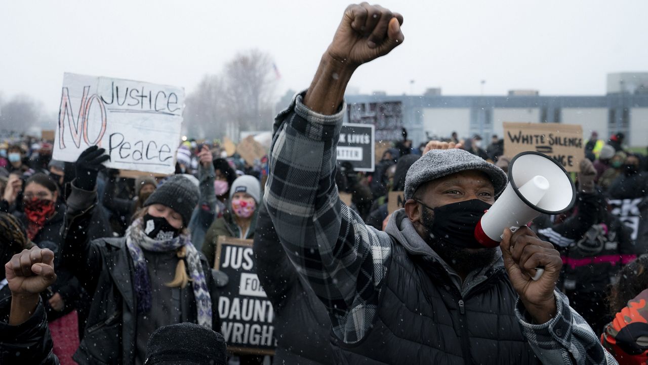 Demonstrators march to the Brooklyn Center Police Department to protest the fatal shooting of Daunte Wright during a traffic stop, Tuesday, April 13, 2021, in Brooklyn Center, Minn. (AP Photo/John Minchillo)