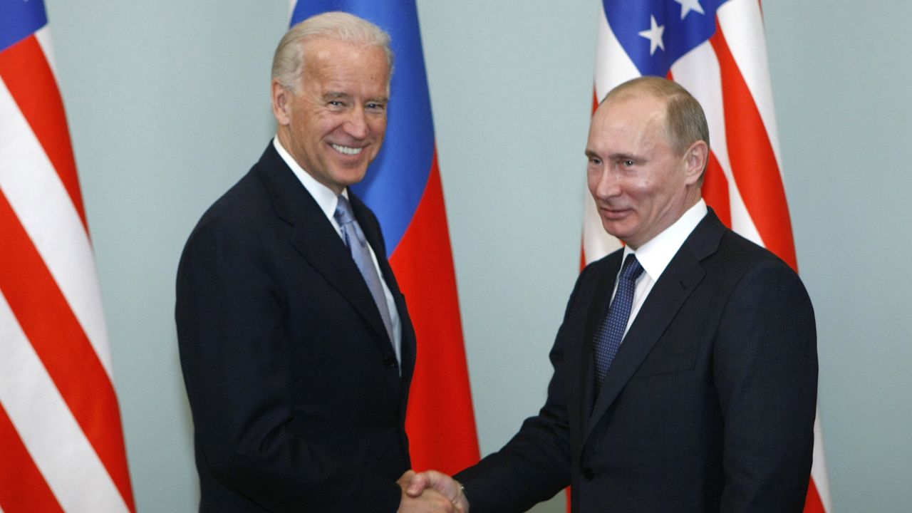 FILE - In this March 10, 2011, file photo, then-Vice President Joe Biden, left, shakes hands with Russian Prime Minister Vladimir Putin in Moscow, Russia. (AP Photo/Alexander Zemlianichenko, File)