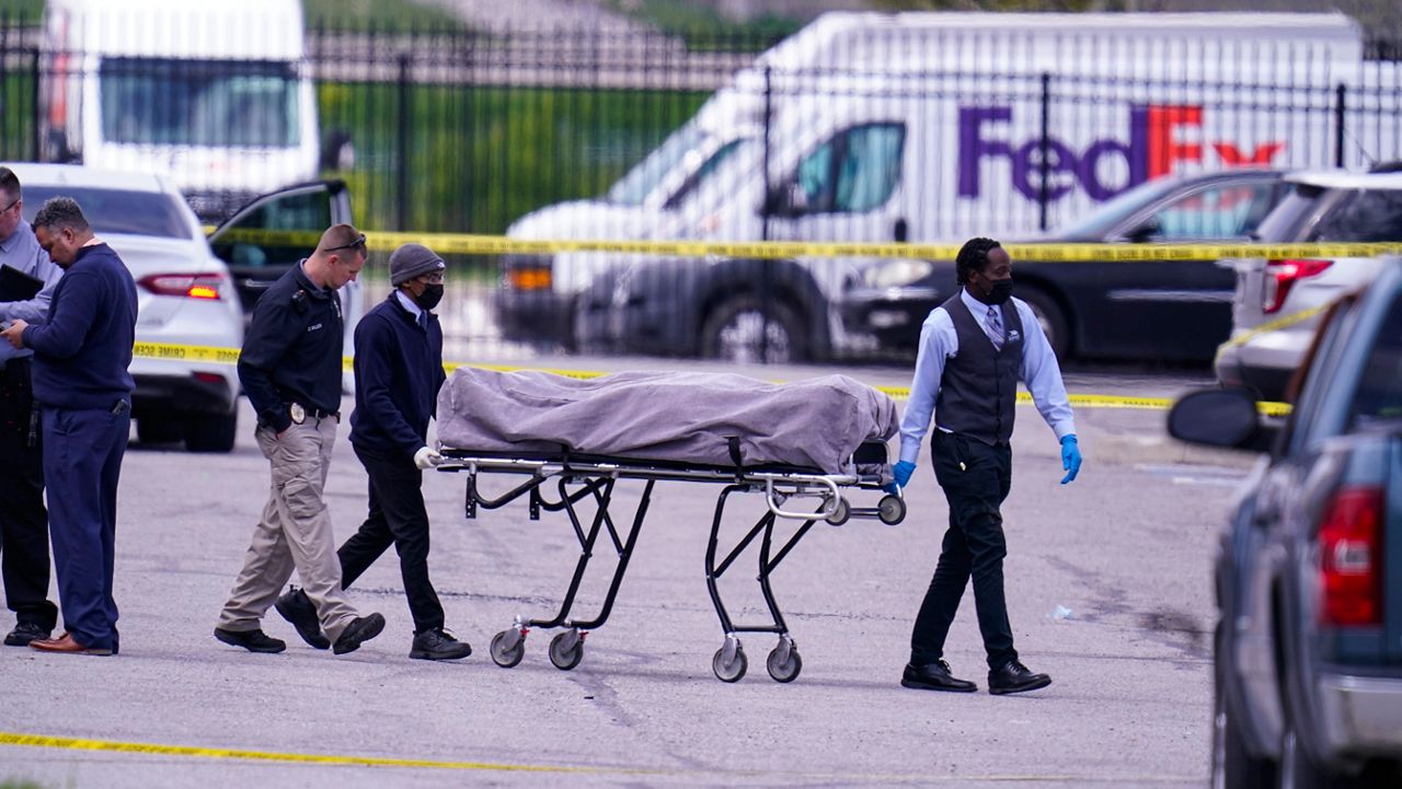 A body is taken from the scene where multiple people were shot at a FedEx Ground facility in Indianapolis, Friday, April 16, 2021. (AP Photo/Michael Conroy)