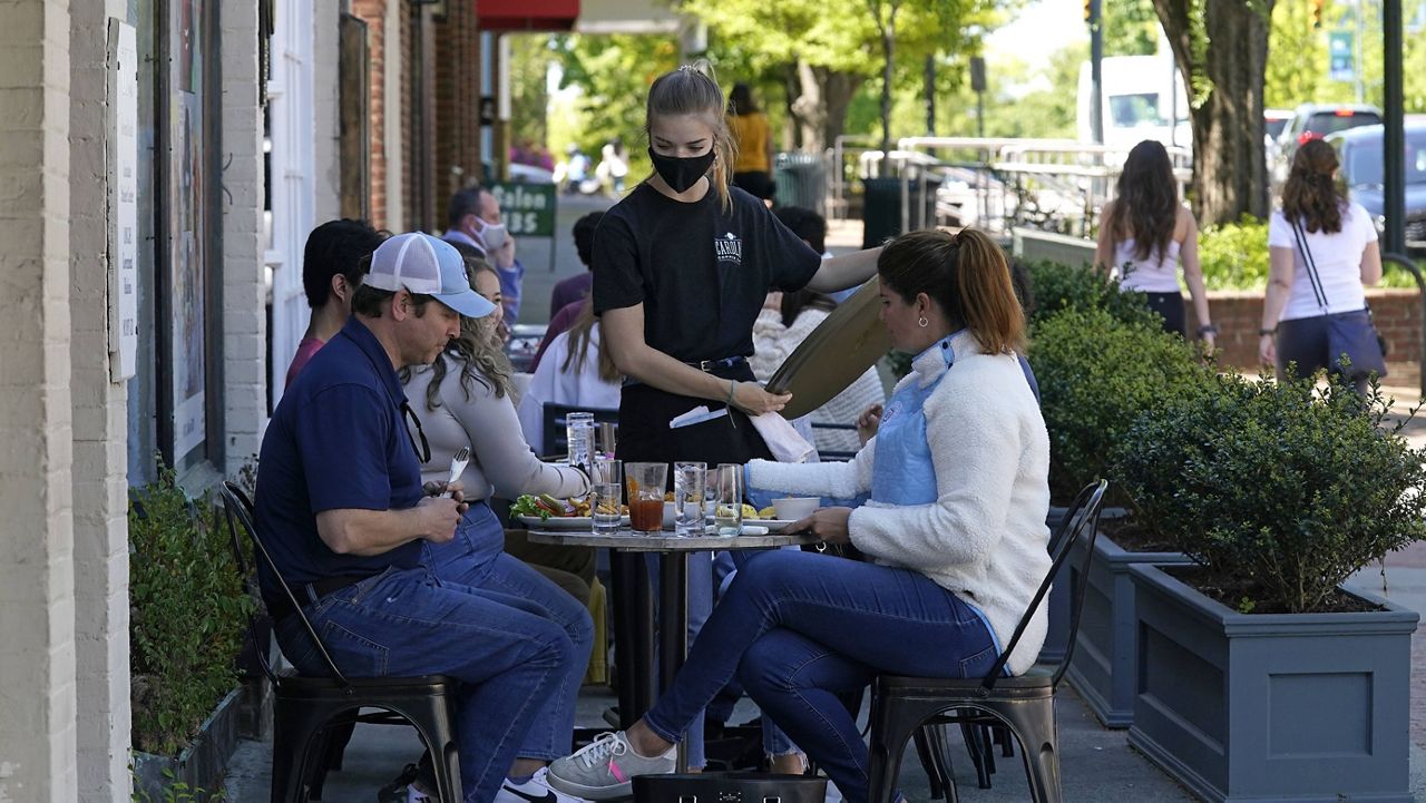 Patrons dine on the sidewalk outside a restaurant in Chapel Hill, N.C. (AP Photo/Gerry Broome, File)