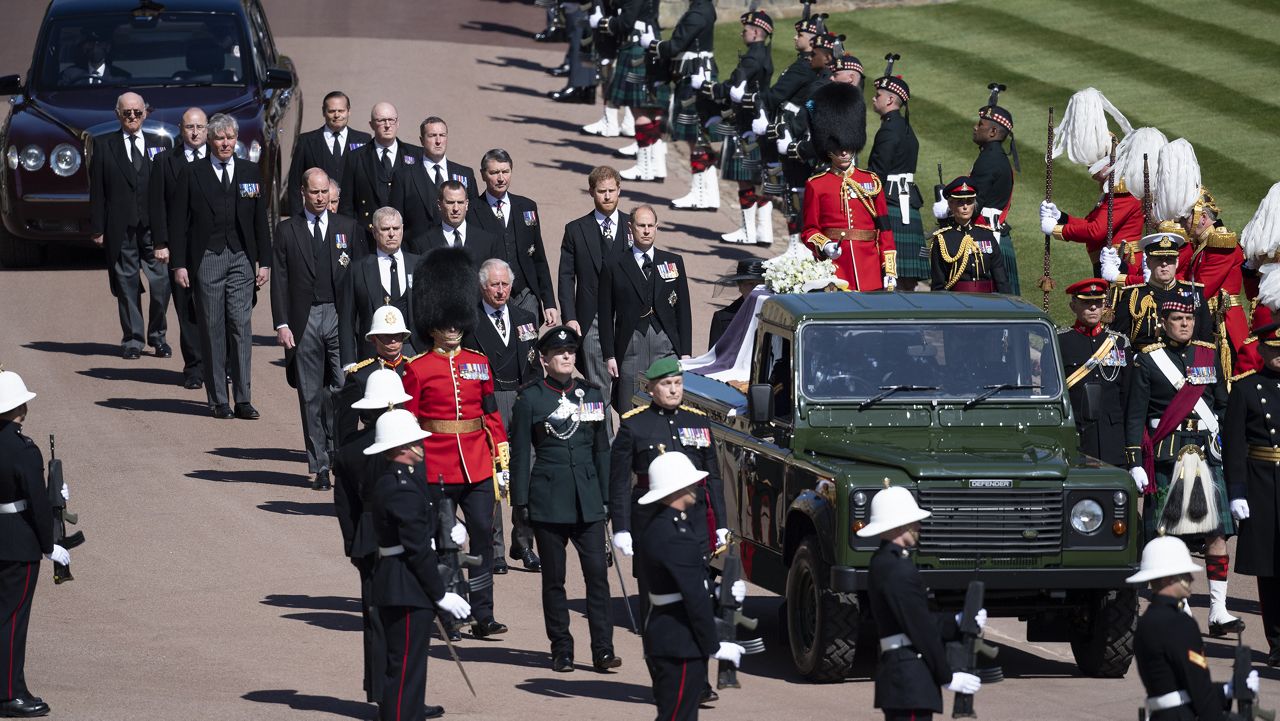 Family members follow the coffin during a procession arriving at St George's Chapel for the funeral of Britain's Prince Philip inside Windsor Castle in Windsor, England, Saturday, April 17, 2021. Prince Philip died April 9 at the age of 99 after 73 years of marriage to Britain's Queen Elizabeth II. (Eddie Mulholland/Pool via AP)